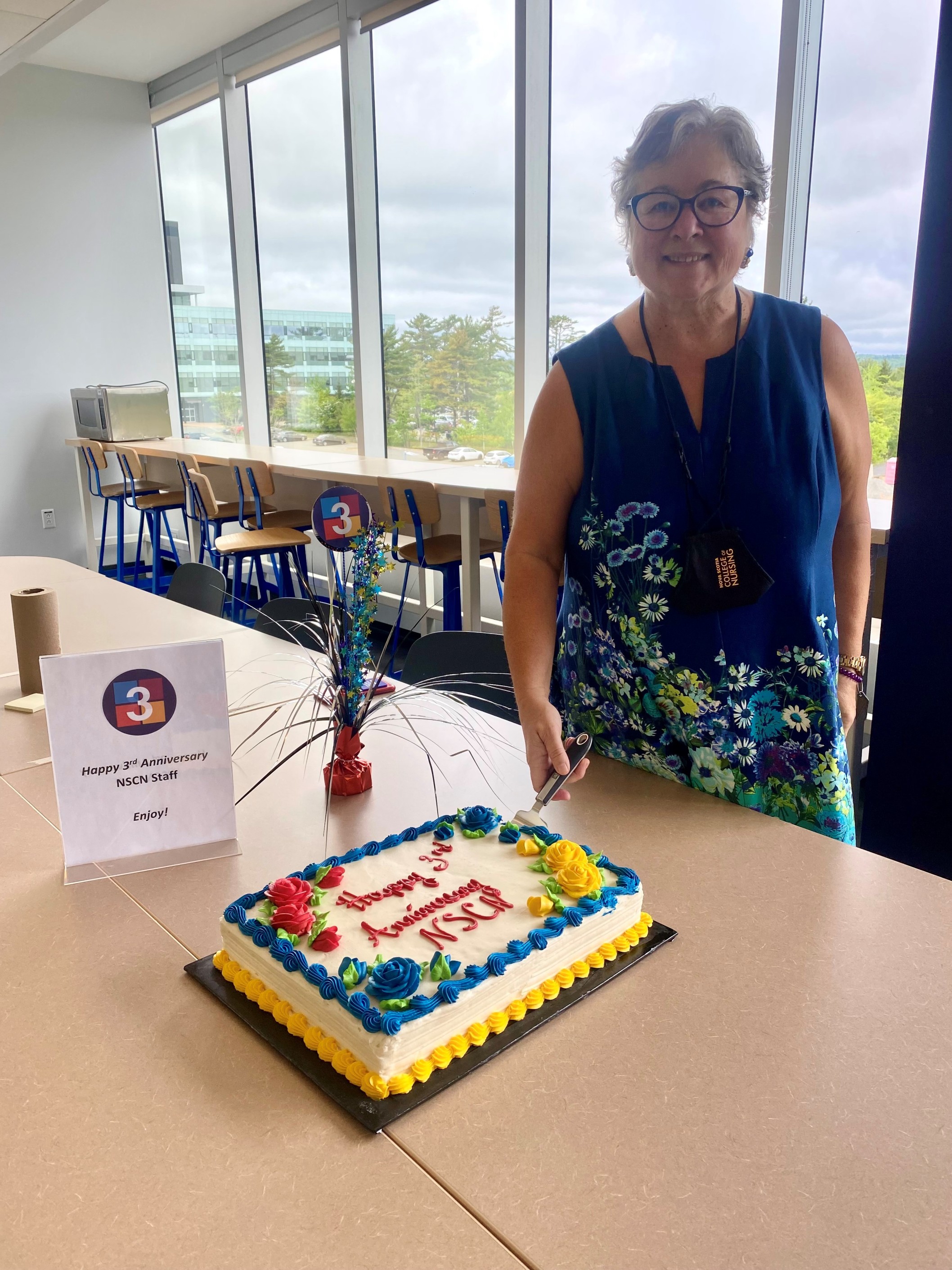 CEO, Sue Smith, cutting cake