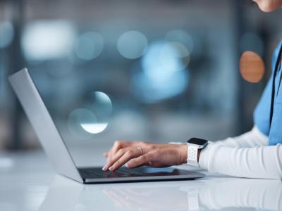 nurse on laptop typing 