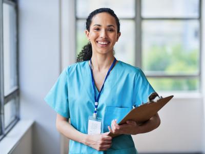 nurse smiling holding clipboard