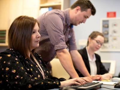 three people at computer