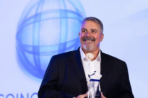 NSCN's CEO, Doug Bungay, holding Catalyst Award 