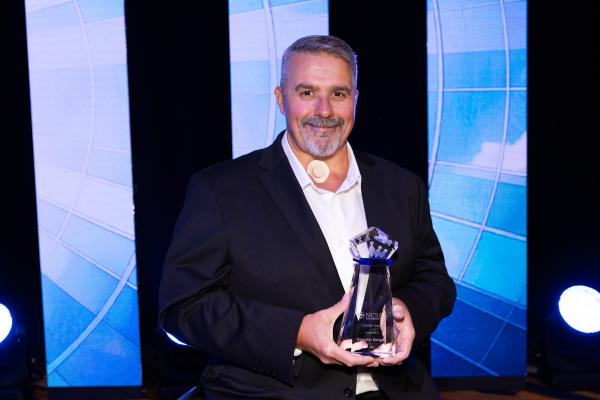 NSCN's CEO, Doug Bungay, holding Catalyst Award 