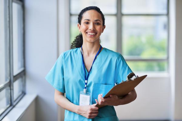 nurse smiling holding clipboard
